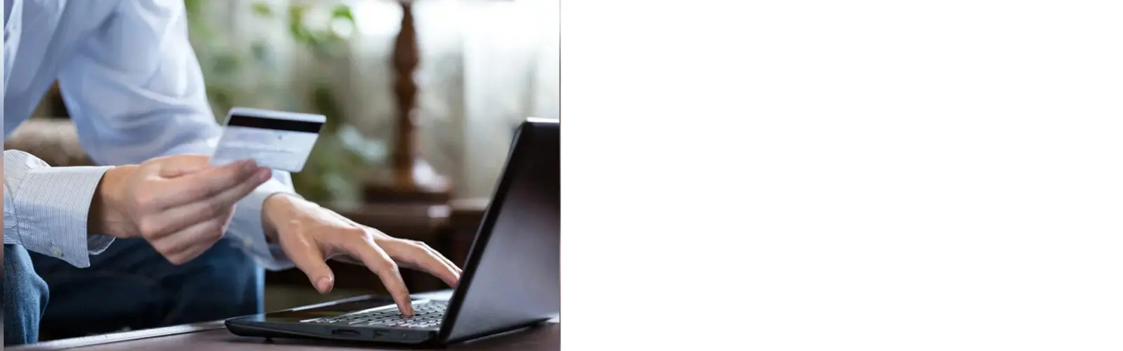 A person using a laptop on top of a table.